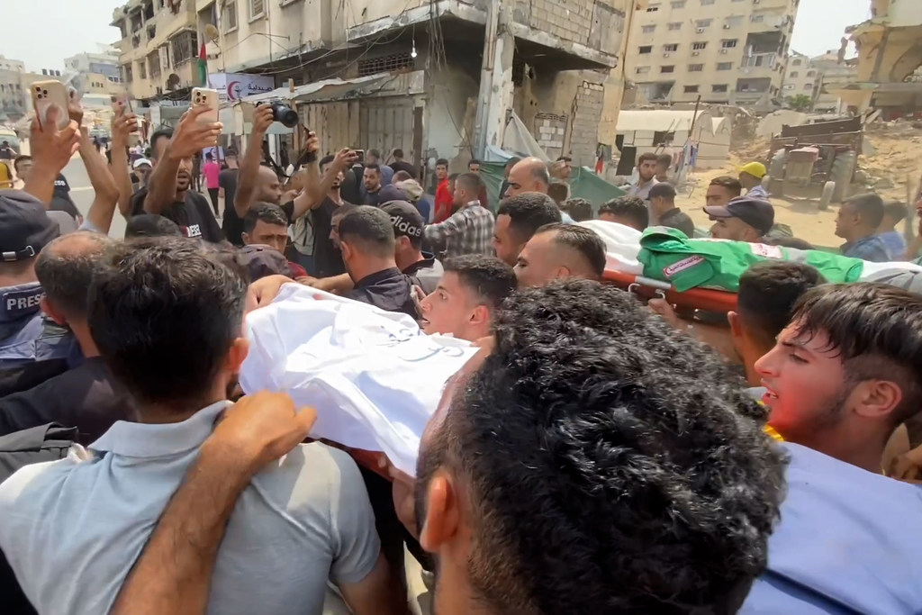Mourners carry the body of a journalist killed in an Israeli airstrike on Gaza on August 10, 2025.
